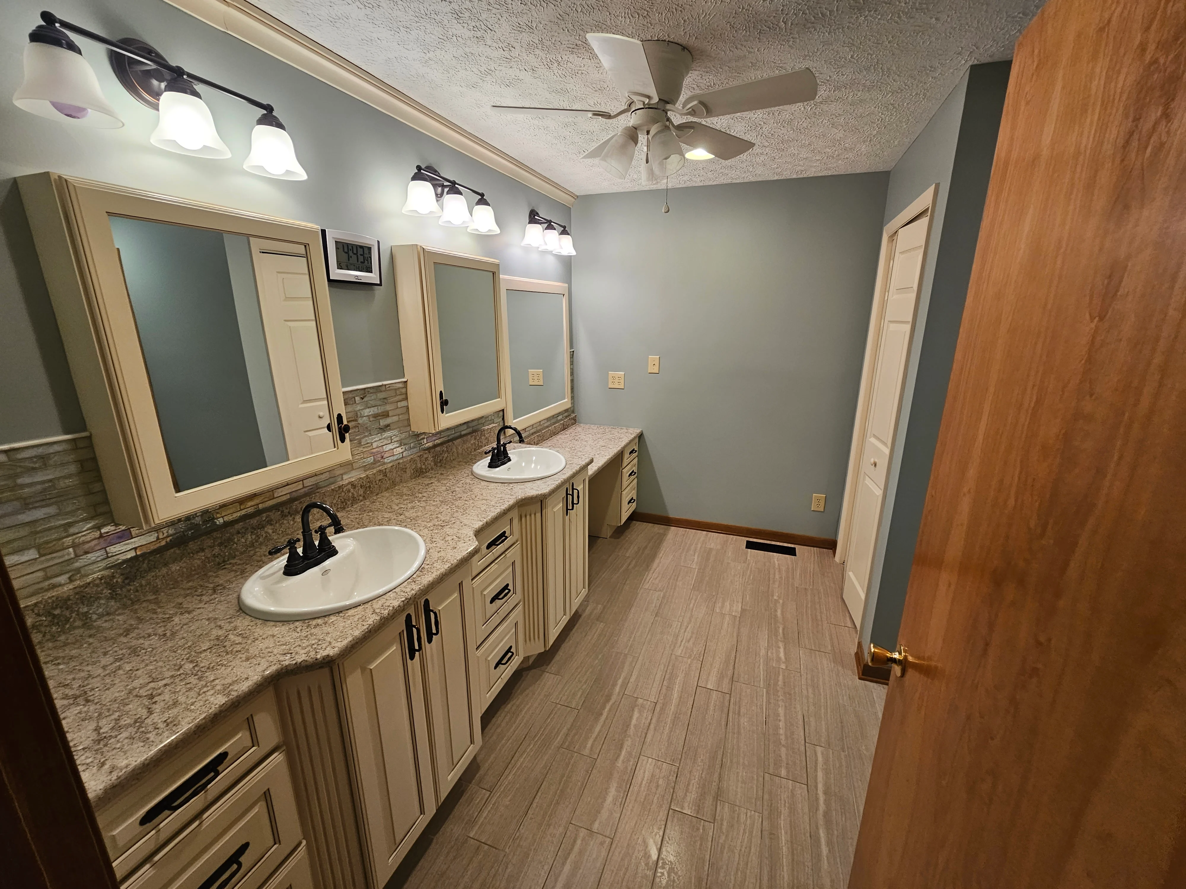 Master bathroom with dual vanities completed by Triple R Construction Inc.